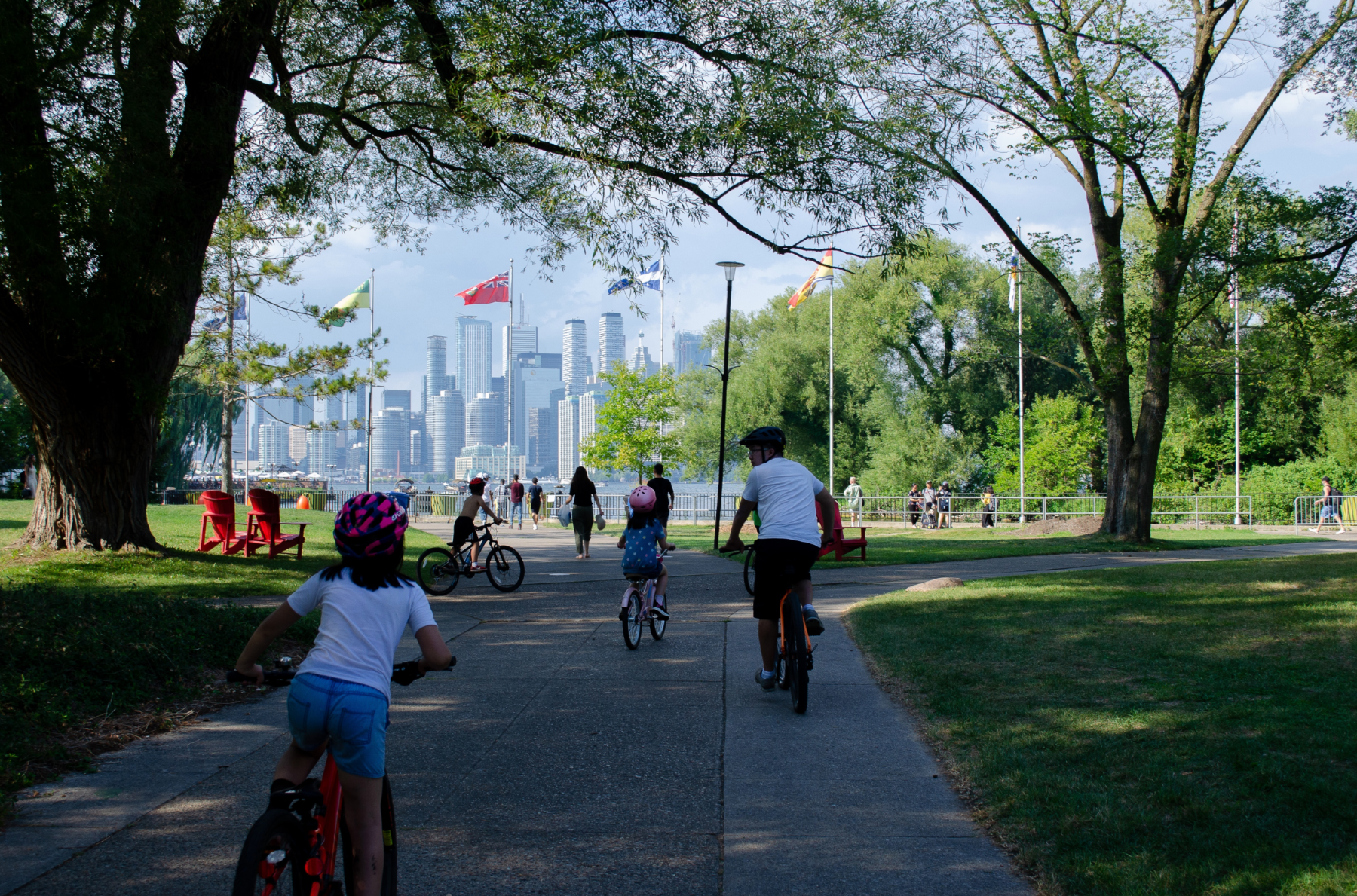 Family riding bicycles through a park.