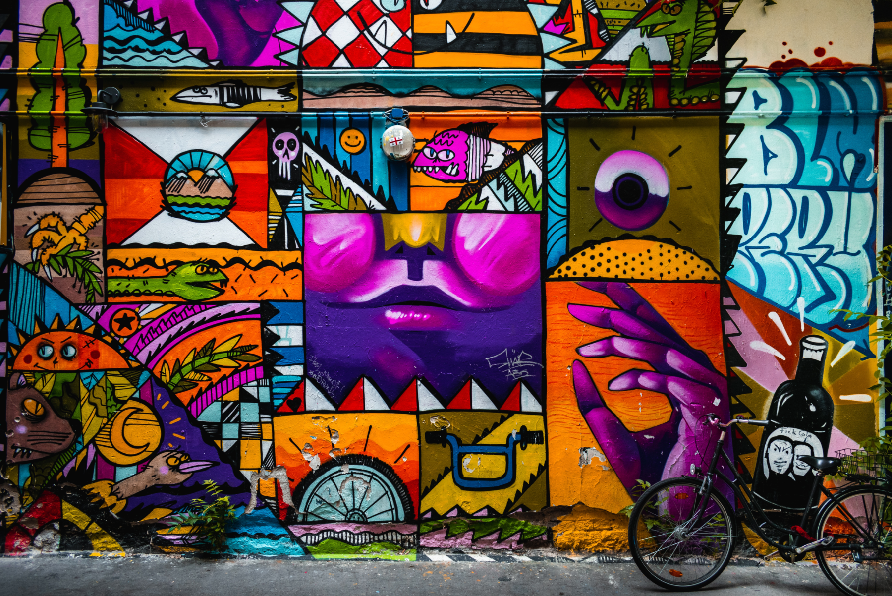 Bike parked next to street art in Berlin, Germany.