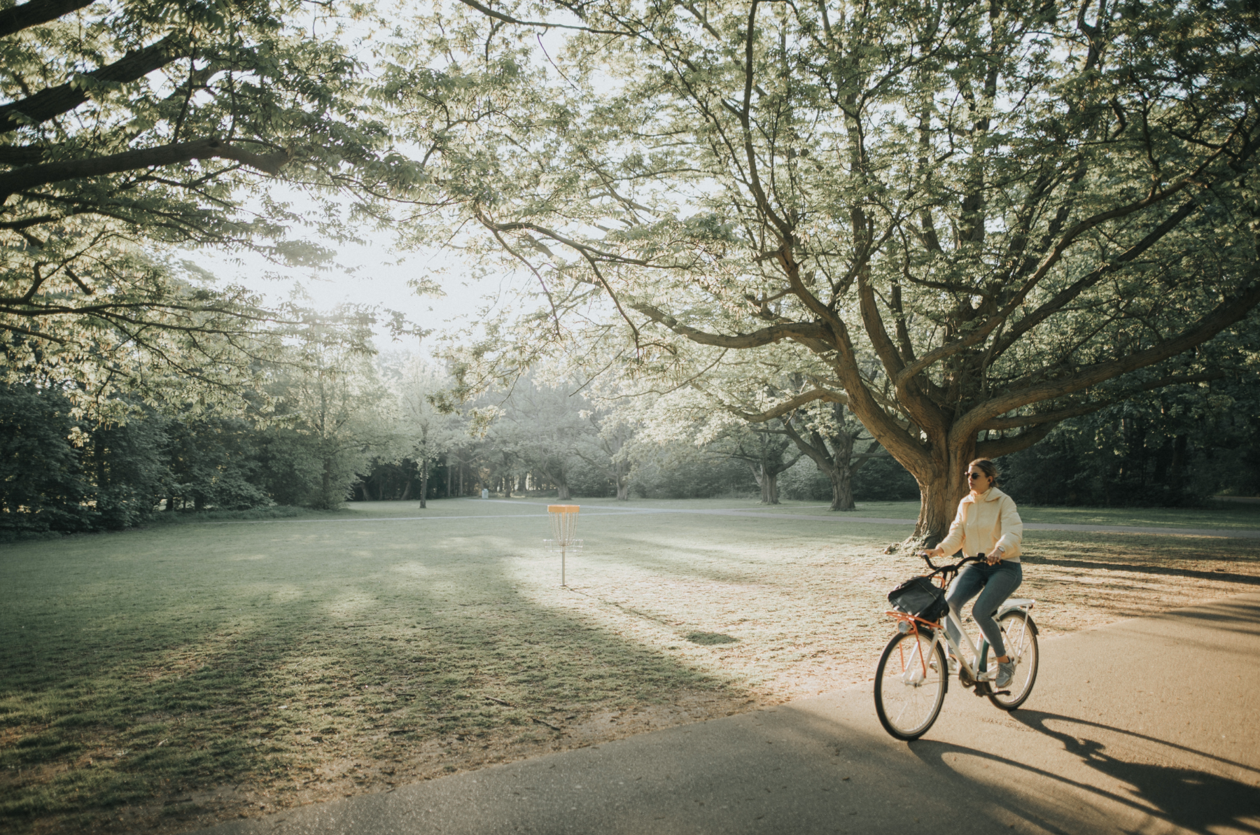 Riding a bicycle through a park.
